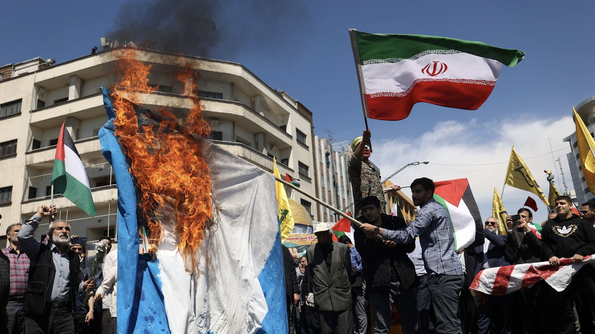 Iranians burn an Israeli flag during a rally marking Quds Day and the funeral of members of the Islamic Revolutionary Guard Corps who were killed in a suspected Israeli airstrike on the Iranian embassy complex in the Syrian capital Damascus, in Tehran, Iran, April 5, 2024. Majid Asgaripour/WANA (West Asia News Agency) via REUTERS ATTENTION EDITORS - THIS IMAGE HAS BEEN SUPPLIED BY A THIRD PARTY